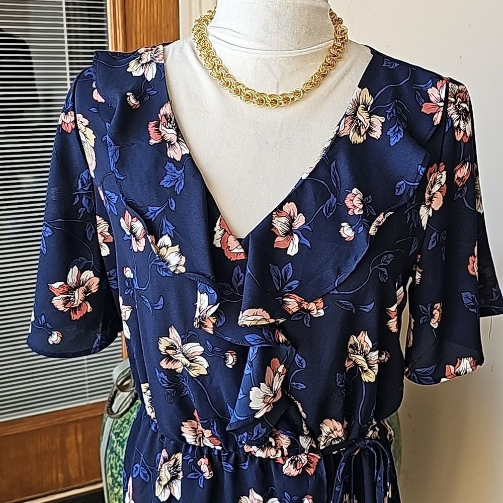 Navy floral pullover top featuring ruffles around v neck size M